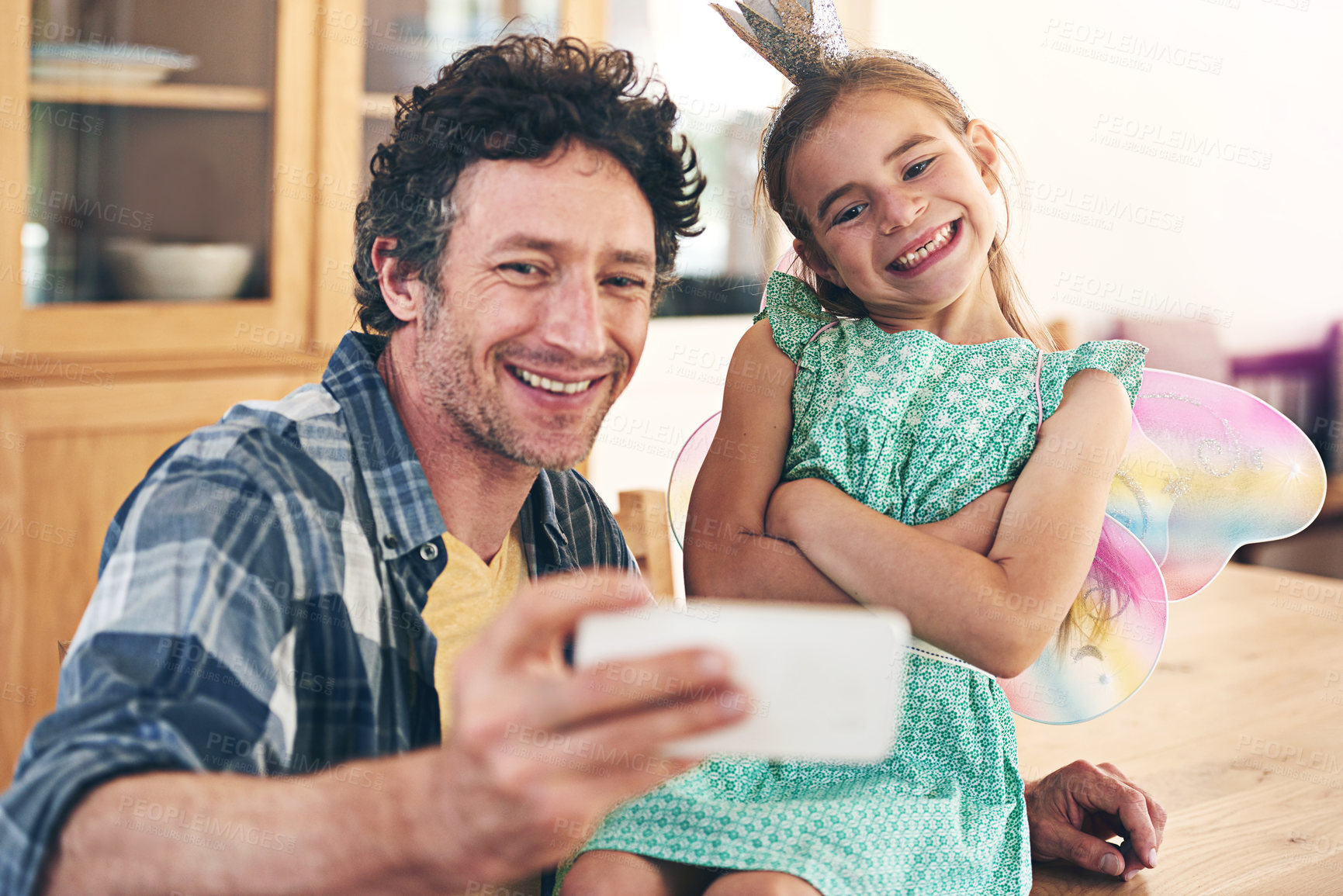 Buy stock photo Happy dad, kid and bonding with selfie for photography, picture or memory together at home. Father, child or little girl with smile or costume for capture, moment or childhood in living room at house