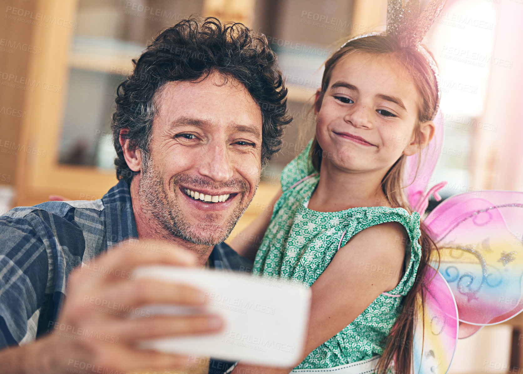 Buy stock photo Happy father, kid and bonding with selfie for photography, picture or memory together at home. Dad, child or little girl with smile or costume for capture, moment or childhood in living room at house