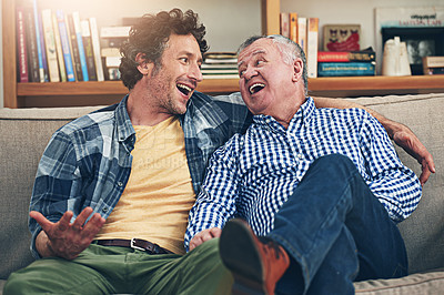 Buy stock photo Shot of a mature man and his elderly father sitting on the sofa at home and having a chat