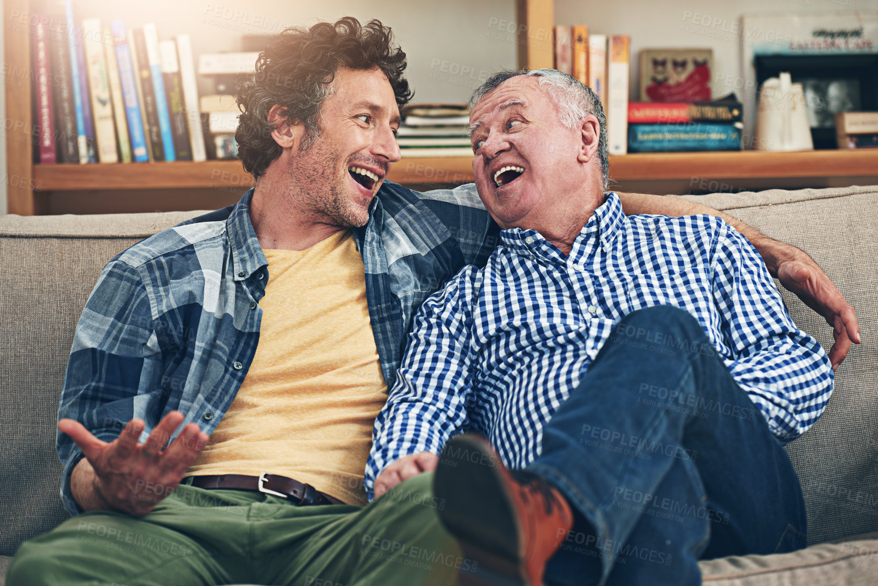 Buy stock photo Shot of a mature man and his elderly father sitting on the sofa at home and having a chat