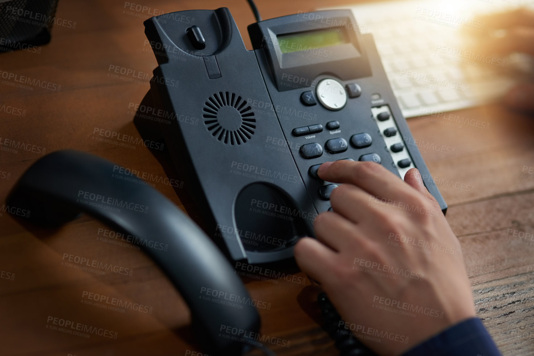Buy stock photo Cropped shot of an unrecognizable man dialling a number on a telephone