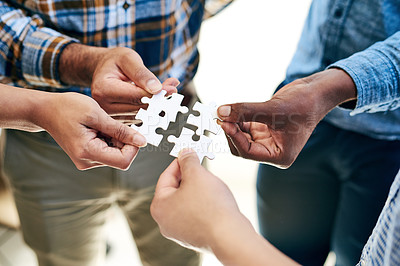 Buy stock photo Cropped shot of a work group connecting pieces of a puzzle