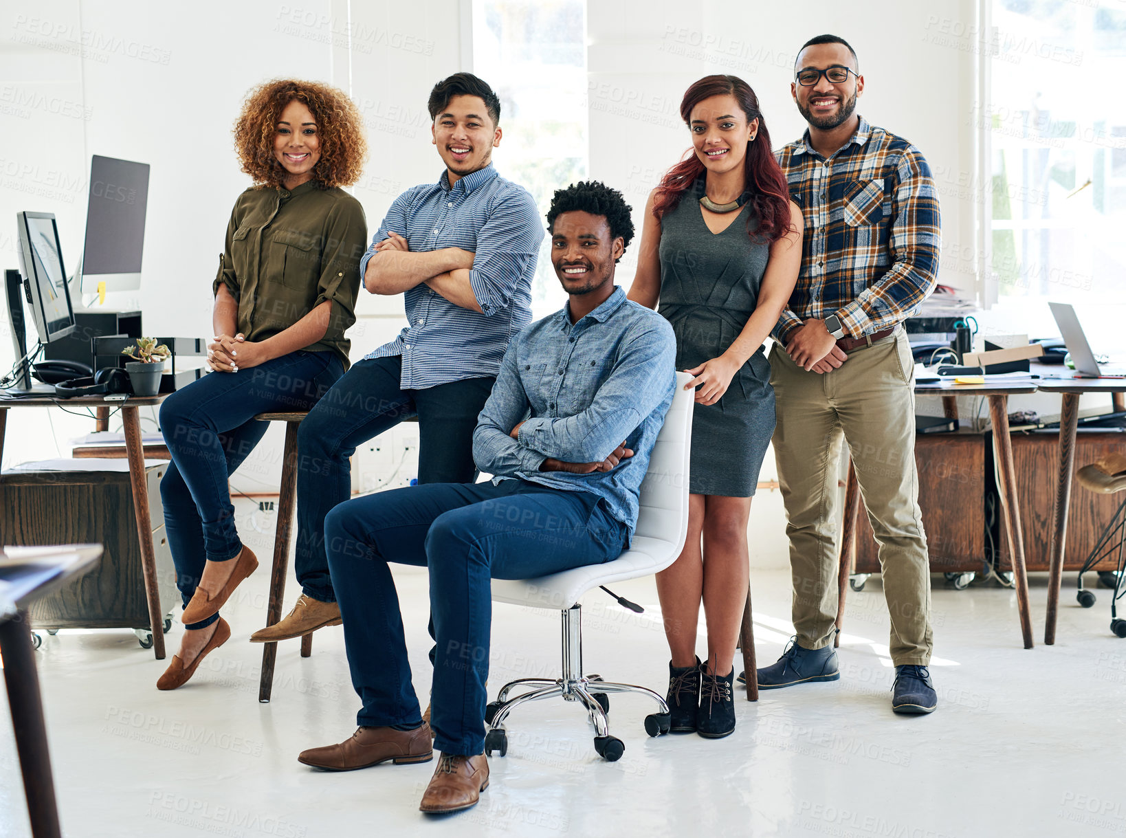 Buy stock photo Portrait of a team of happy and confident colleagues working in a modern office
