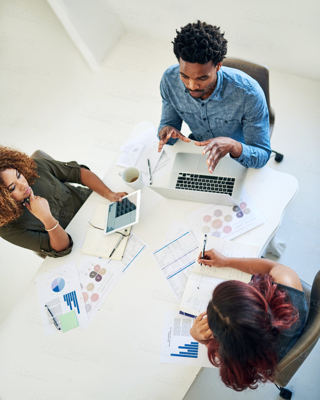 Buy stock photo Shot of a group of colleagues having a meeting in a modern office