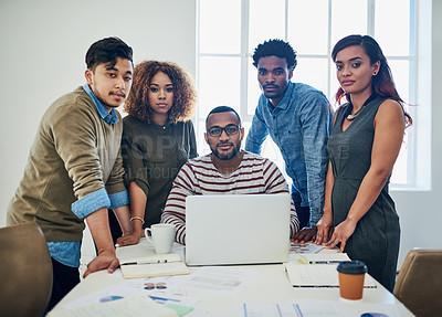 Buy stock photo Portrait of a group of colleagues using a laptop together in a modern office