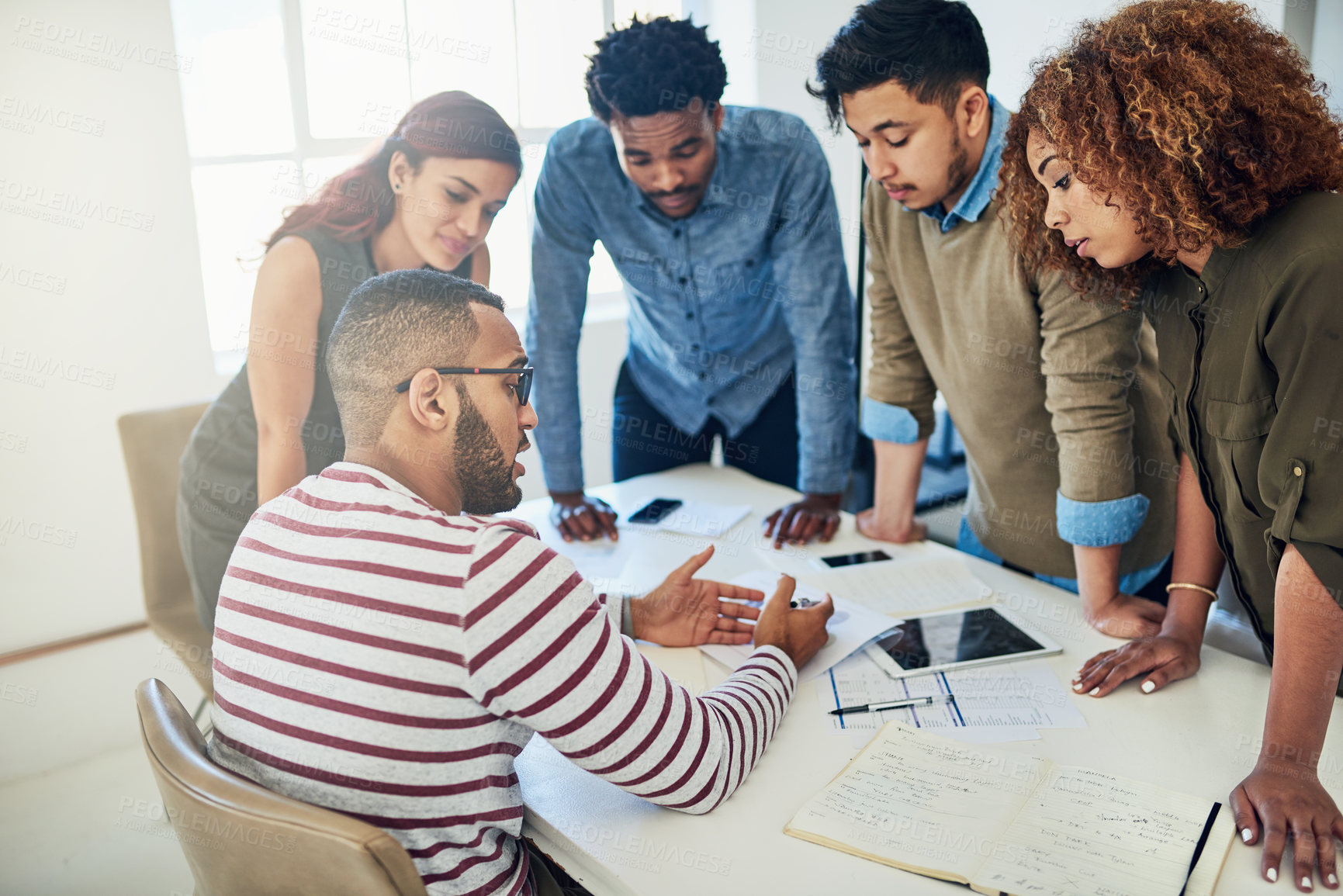 Buy stock photo Business people, group and feedback in meeting, digital agency and planning for project. Behind, employees or graphic designer with documents for review, projections for development and collaboration