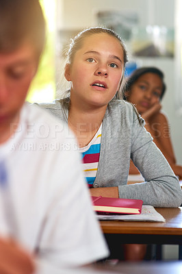 Buy stock photo Shot of a group of schoolchildren concentrating on their lesson in class
