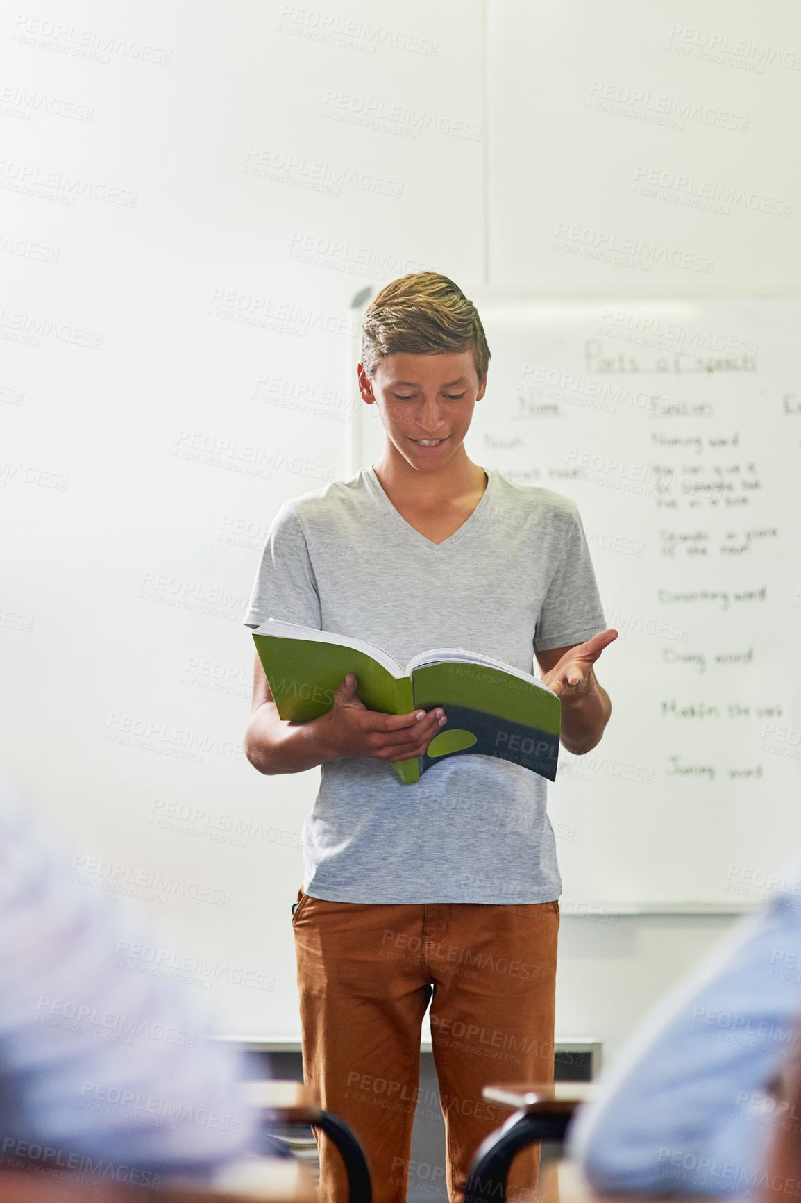 Buy stock photo Classroom, young boy or learner reading book for education, research and development of literacy skill. Presentation, student and novel for communication, studying and school project or oral