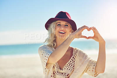 Buy stock photo Woman, hands and heart with portrait on beach for love for travel or tourism, happiness and outdoor venue review for destinations. Girl, romantic gesture or symbol by ocean in Australia for vacation.