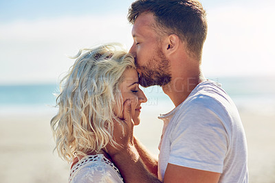 Buy stock photo Cropped shot of n affectionate couple spending the day at the beach