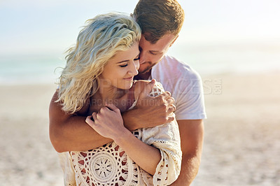 Buy stock photo Cropped shot of n affectionate couple spending the day at the beach