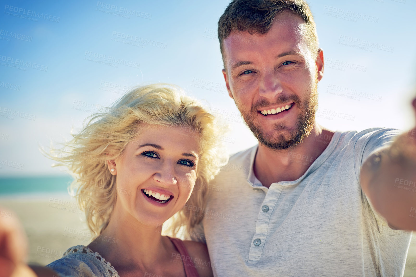 Buy stock photo Cropped shot of n affectionate couple spending the day at the beach