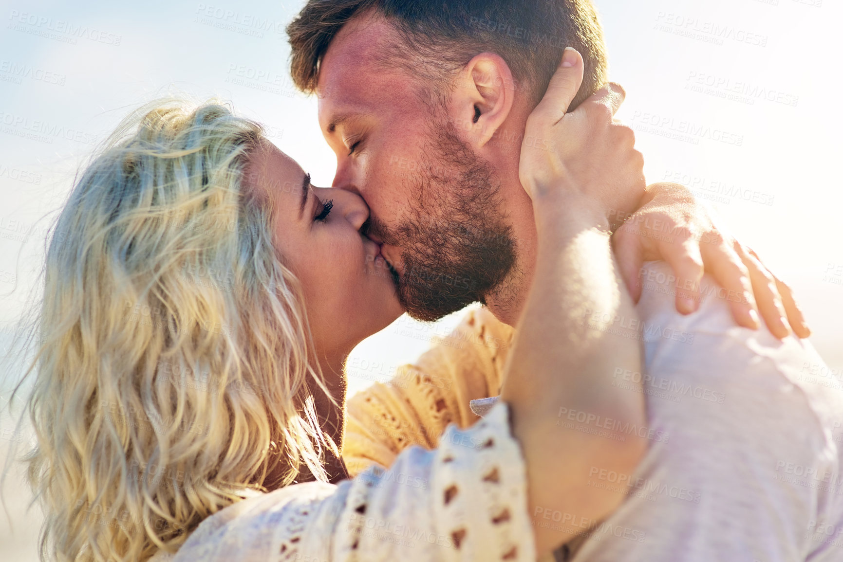 Buy stock photo Happy, couple and kiss on outdoor with love for vacation romance, summer holiday and trip with affection. Man, woman and hug for bonding by beach on weekend date, embrace and support with care.