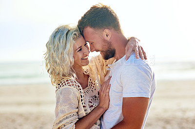 Buy stock photo Cropped shot of n affectionate couple spending the day at the beach