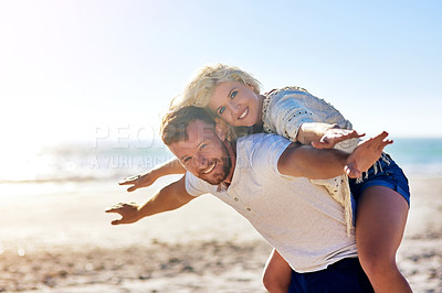 Buy stock photo Cropped shot of n affectionate couple spending the day at the beach