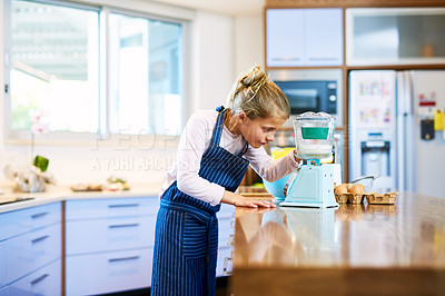 Buy stock photo Cropped shot of a little girl measuring ingredients on a scale while baking at home