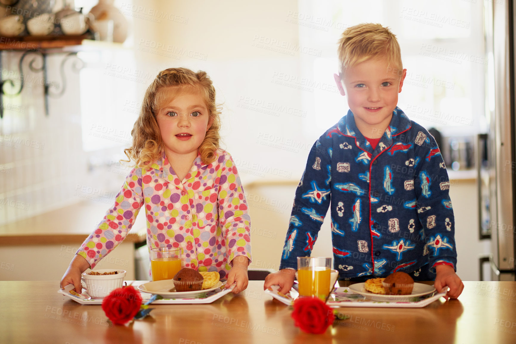 Buy stock photo Portrait of two adorable little siblings preparing breakfast on serving trays at home