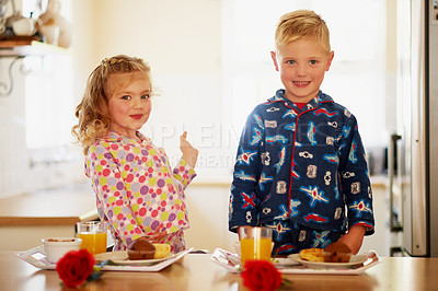 Buy stock photo Portrait of two adorable little siblings preparing breakfast on serving trays at home