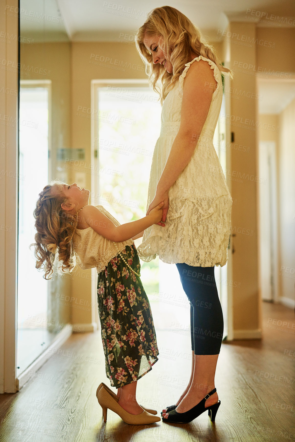 Buy stock photo Shot of a mother and her little daughter playing dress-up at home