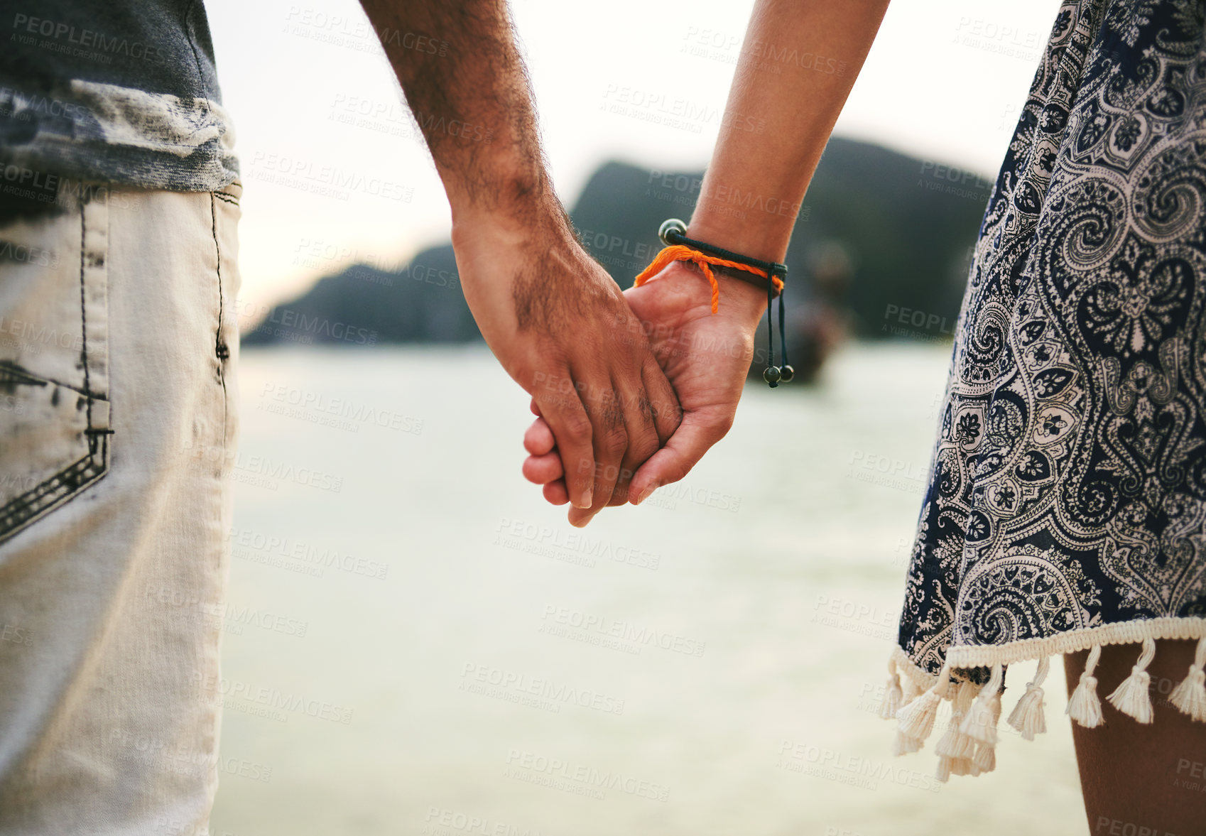 Buy stock photo Happy couple, trust and holding hands for love on beach for memory, date or holiday in relationship as partner. Woman, man and together in destination for commitment, anniversary on vacation in Italy