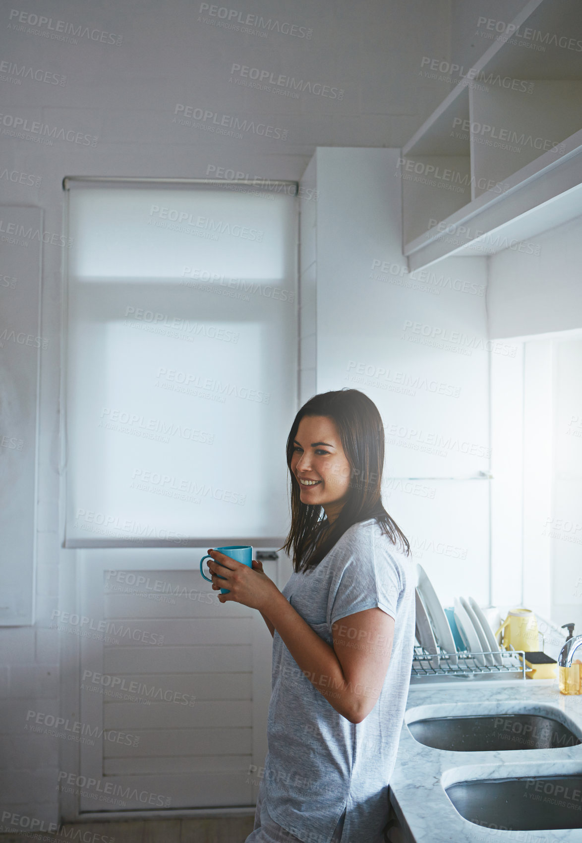 Buy stock photo Calm, coffee and happy with woman in kitchen in home for morning, smile and wellness drink. Relax, wake up beverage and drinking tea with female person and mug in house for weekend break and peace