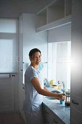 Buy stock photo Cropped portrait of an attractive young woman preparing a pot of coffee in the kitchen