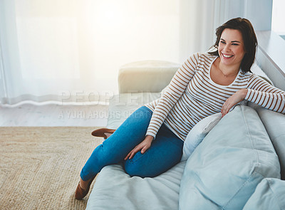 Buy stock photo Shot of an happy young woman relaxing on the sofa at home