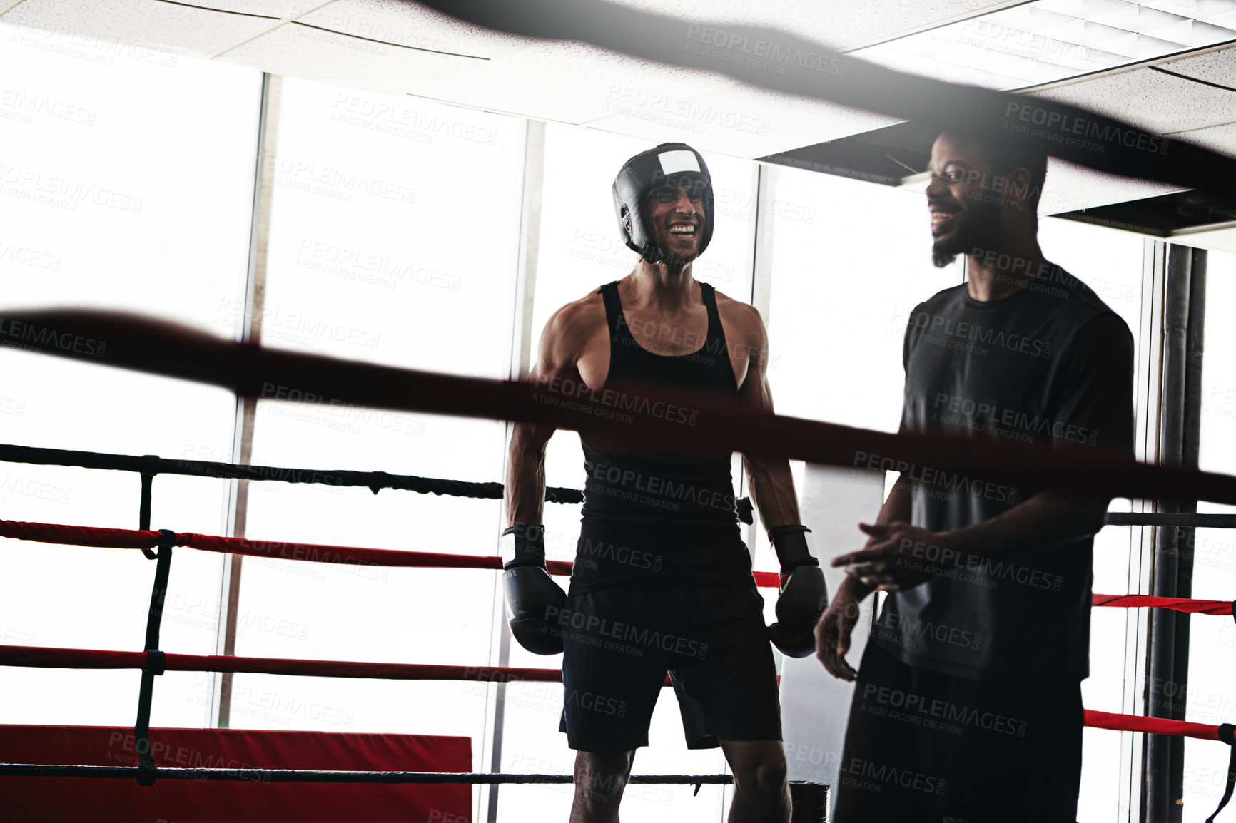 Buy stock photo Shot of a man training in the boxing ring with a coach