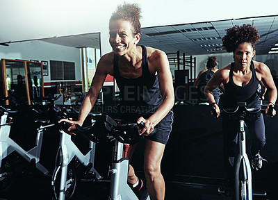 Buy stock photo Exercise bike, fitness and women in gym, progress or high energy with endurance, cycling or challenge. People, performance or girls with training, cardio or body workout with hobby, sports or support