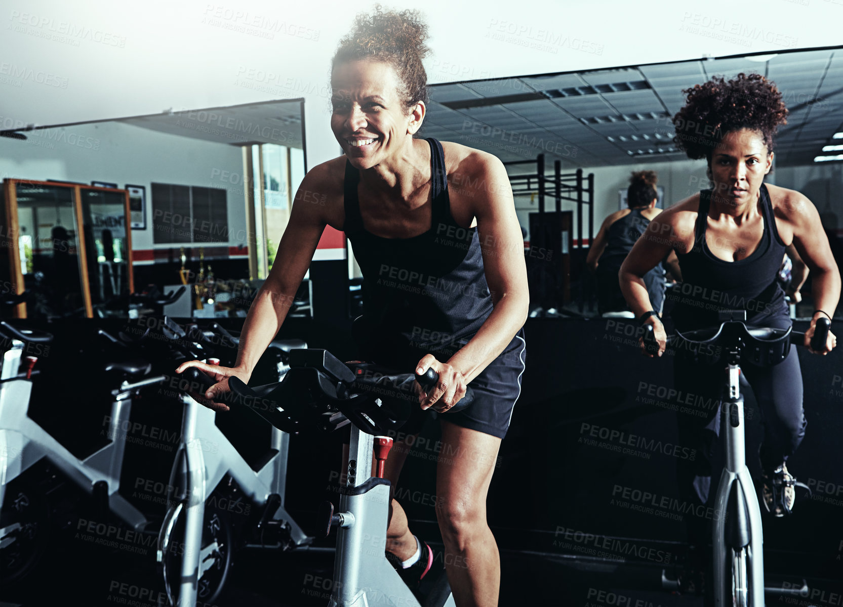 Buy stock photo Exercise bike, fitness and women in gym, progress or high energy with endurance, cycling or challenge. People, performance or girls with training, cardio or body workout with hobby, sports or support