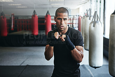 Buy stock photo Portrait, punching and man in gym for exercise, boxing challenge or competition training. Power, muscle and champion boxer at workout with confidence, fight and energy in MMA sports club with gloves.