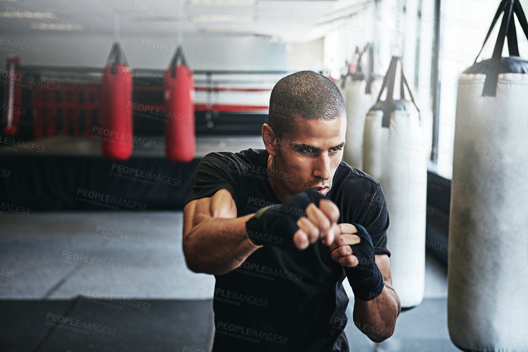 Buy stock photo Fitness, punching and man in boxing ring for gym, challenge or competition training. Power, muscle and champion boxer at workout with confidence, fight and energy in MMA sports club with gloves.