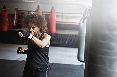 Buy stock photo Fitness, punching bag and mature woman in boxing ring for gym, challenge or competition training. Power, muscle and champion boxer at workout with confidence, fight and energy in MMA sports club.