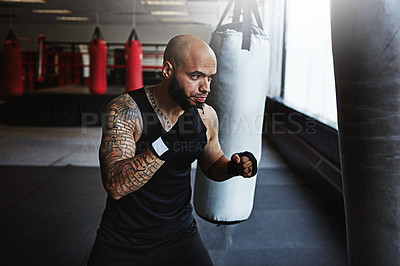 Buy stock photo Cropped shot of a kick-boxer training in a gym