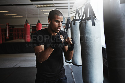 Buy stock photo Power, punching bag and man in boxing ring for workout, challenge or competition training. Fitness, muscle and strong champion boxer in exercise with confidence, fight and energy in MMA sports club.