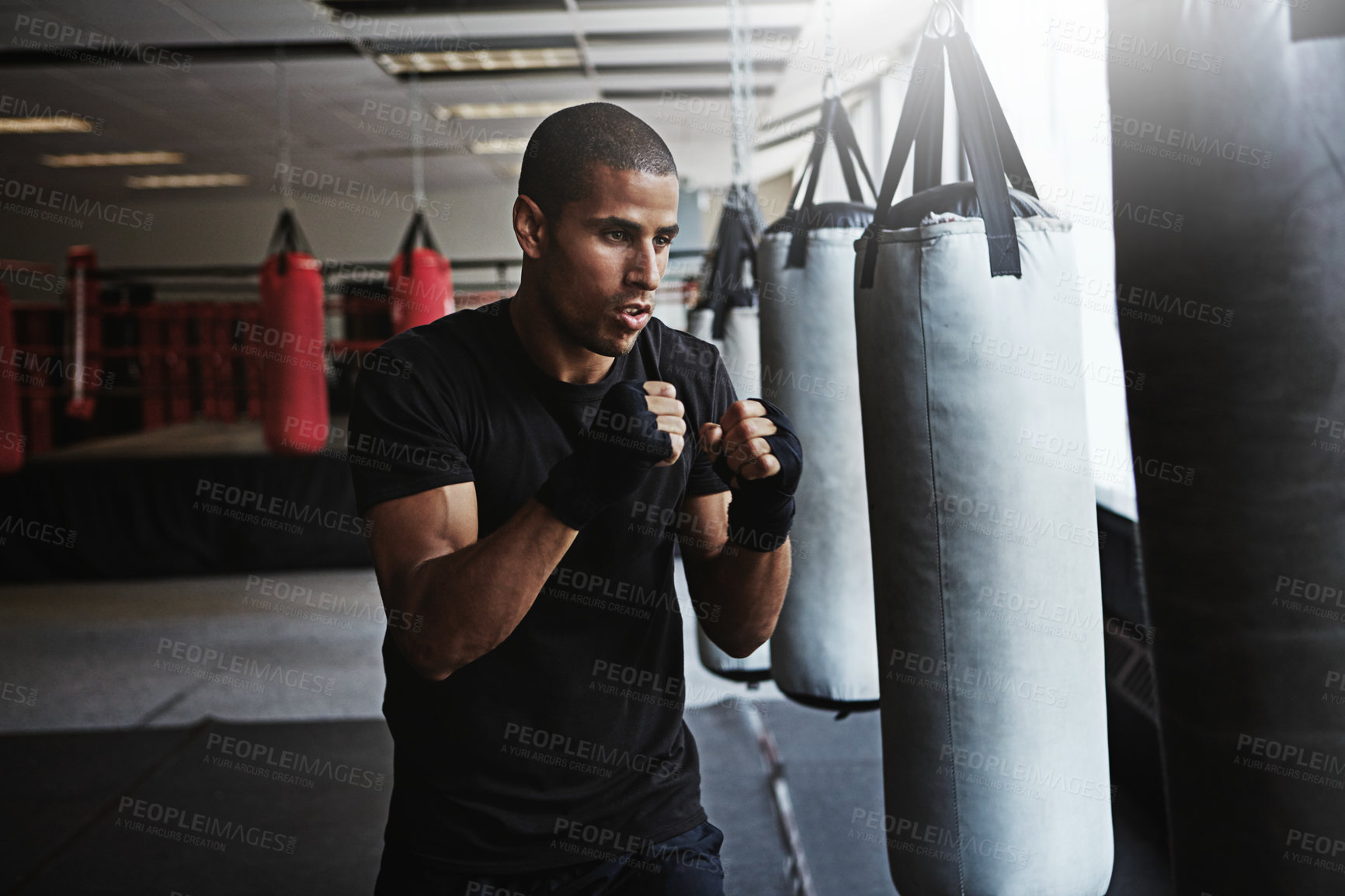 Buy stock photo Power, punching bag and man in boxing ring for workout, challenge or competition training. Fitness, muscle and strong champion boxer in exercise with confidence, fight and energy in MMA sports club.