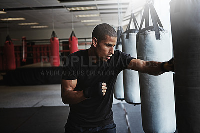 Buy stock photo Hit, punching bag and man in boxing gym for workout, challenge or competition training. Power, muscle and strong champion boxer in exercise with confidence, fitness and energy in MMA sports club.