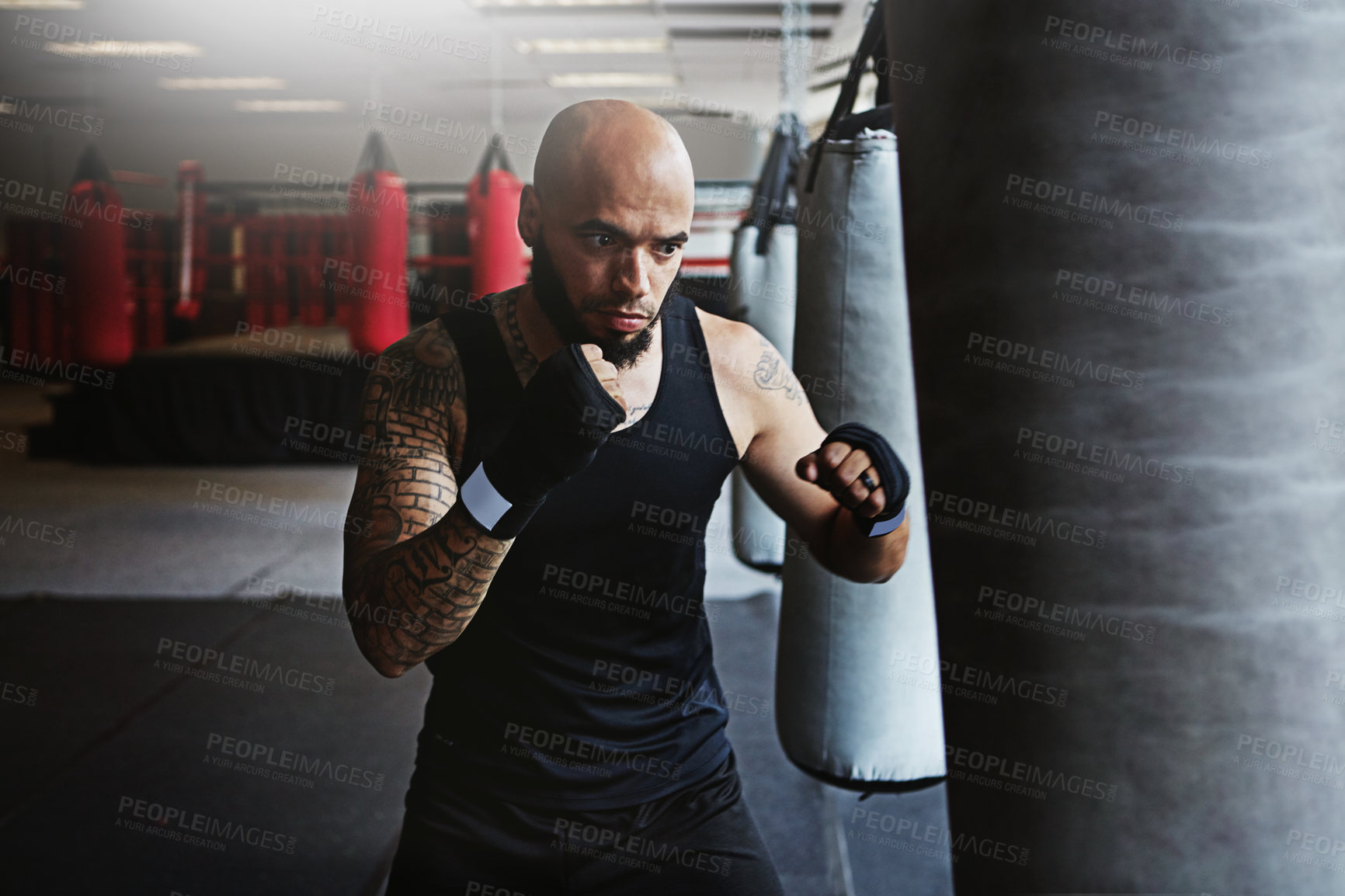 Buy stock photo Training, punching bag and man in boxing ring for workout, challenge or fitness competition. Power, muscle and strong champion boxer in exercise with confidence, fight and energy in MMA sports club.