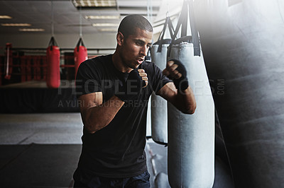 Buy stock photo Fitness, punching bag and man in boxing workout, gym challenge or serious competition training. Power, muscle and strong champion boxer in exercise with confidence, fight or energy in MMA sports club