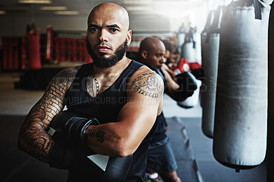 Buy stock photo Shot of a male boxer training at the gym