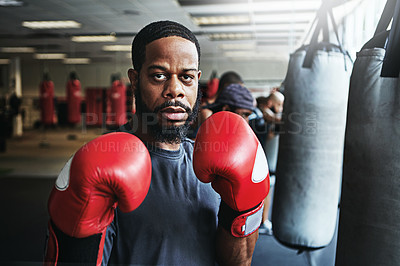 Buy stock photo Shot of a male boxer training at the gym