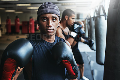 Buy stock photo Shot of a male boxer training at the gym