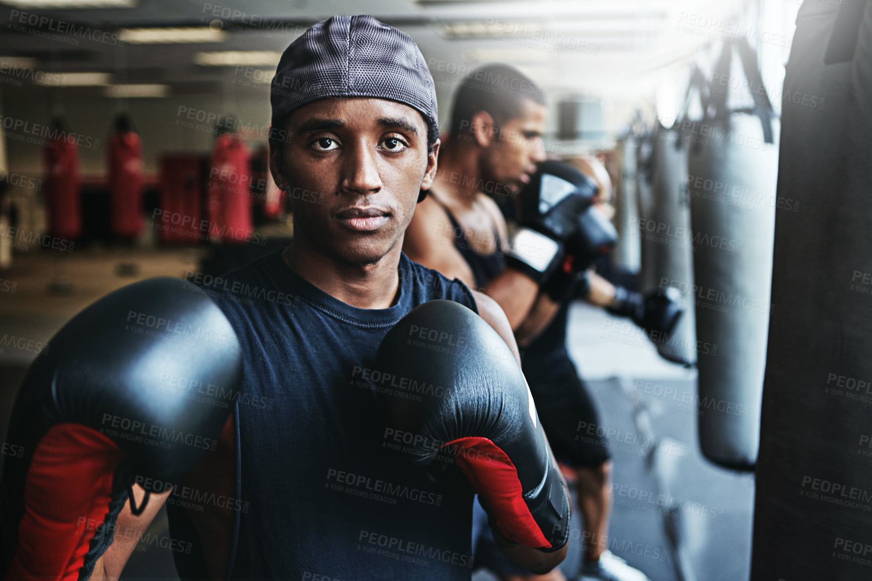 Buy stock photo Shot of a male boxer training at the gym