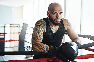 Buy stock photo Serious, boxer and man on rope in ring for challenge, exercise and training competition for body health. Thinking, fight and sport athlete resting on break for fitness, workout or wellness at gym