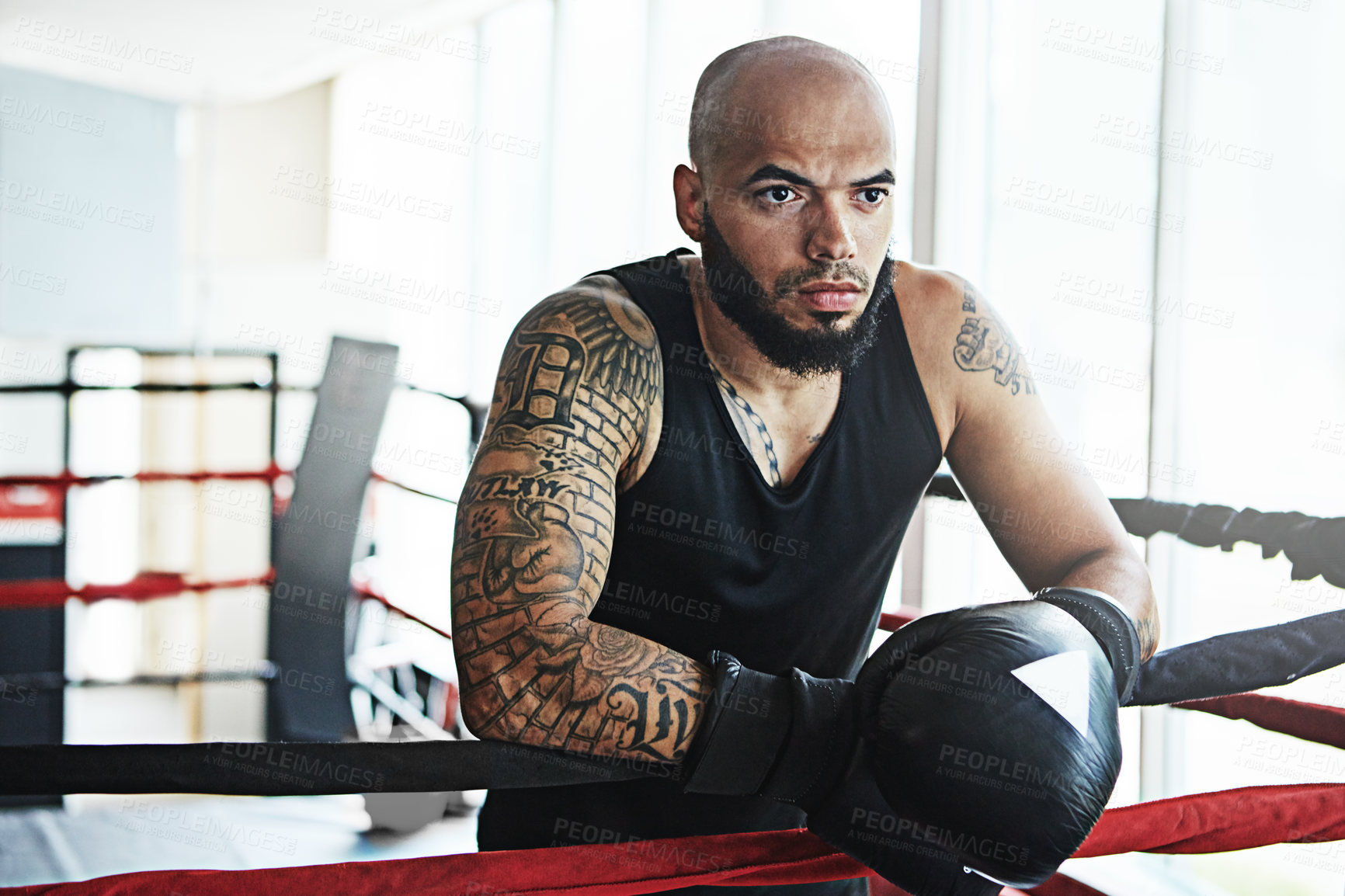 Buy stock photo Serious, boxer and man on rope in ring for challenge, exercise and training competition for body health. Thinking, fight and sport athlete resting on break for fitness, workout or wellness at gym