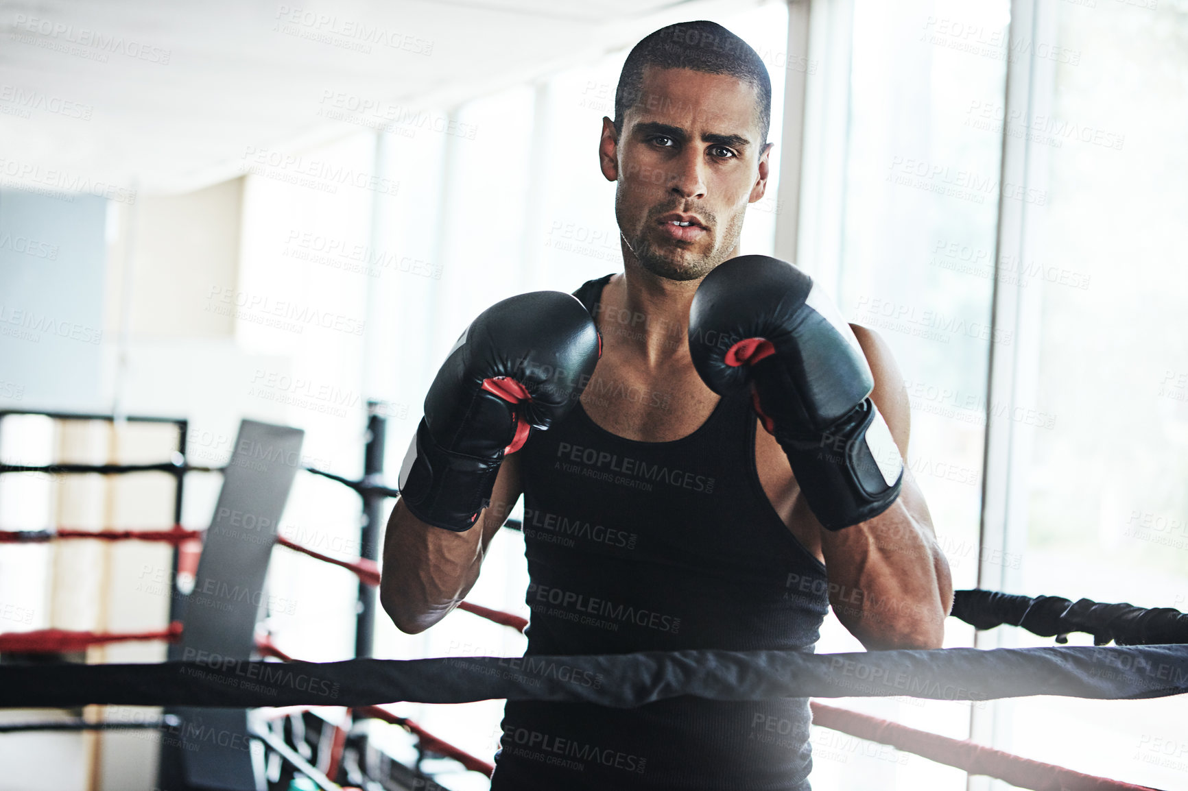 Buy stock photo Portrait of a young man training in a boxing ring