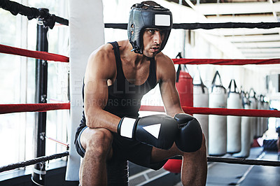 Buy stock photo Shot of a young man training in a boxing ring