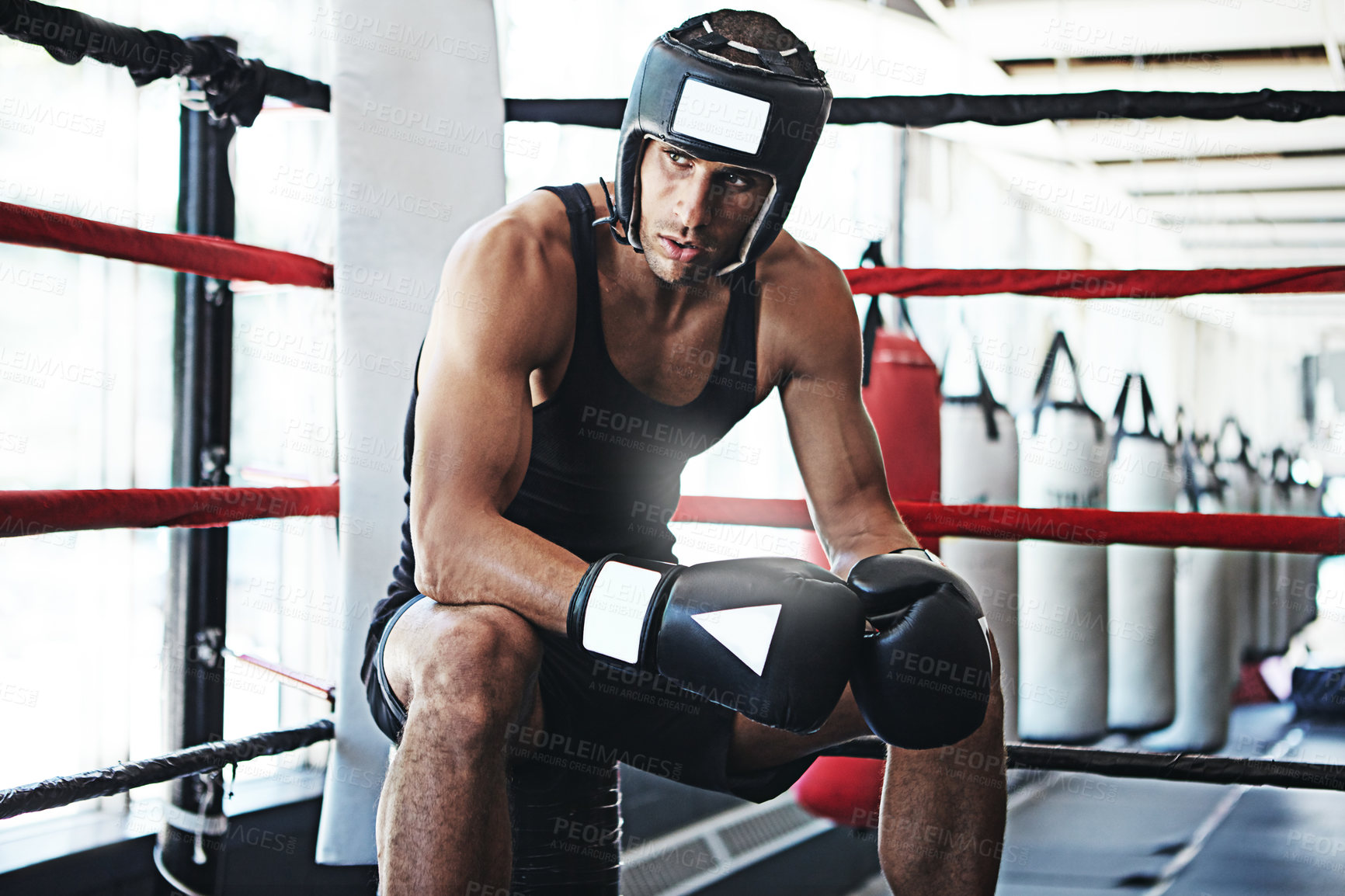 Buy stock photo Shot of a young man training in a boxing ring