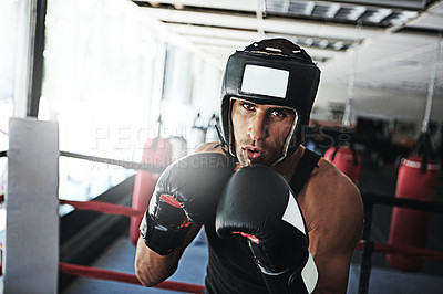 Buy stock photo Portrait of a young man training in a boxing ring