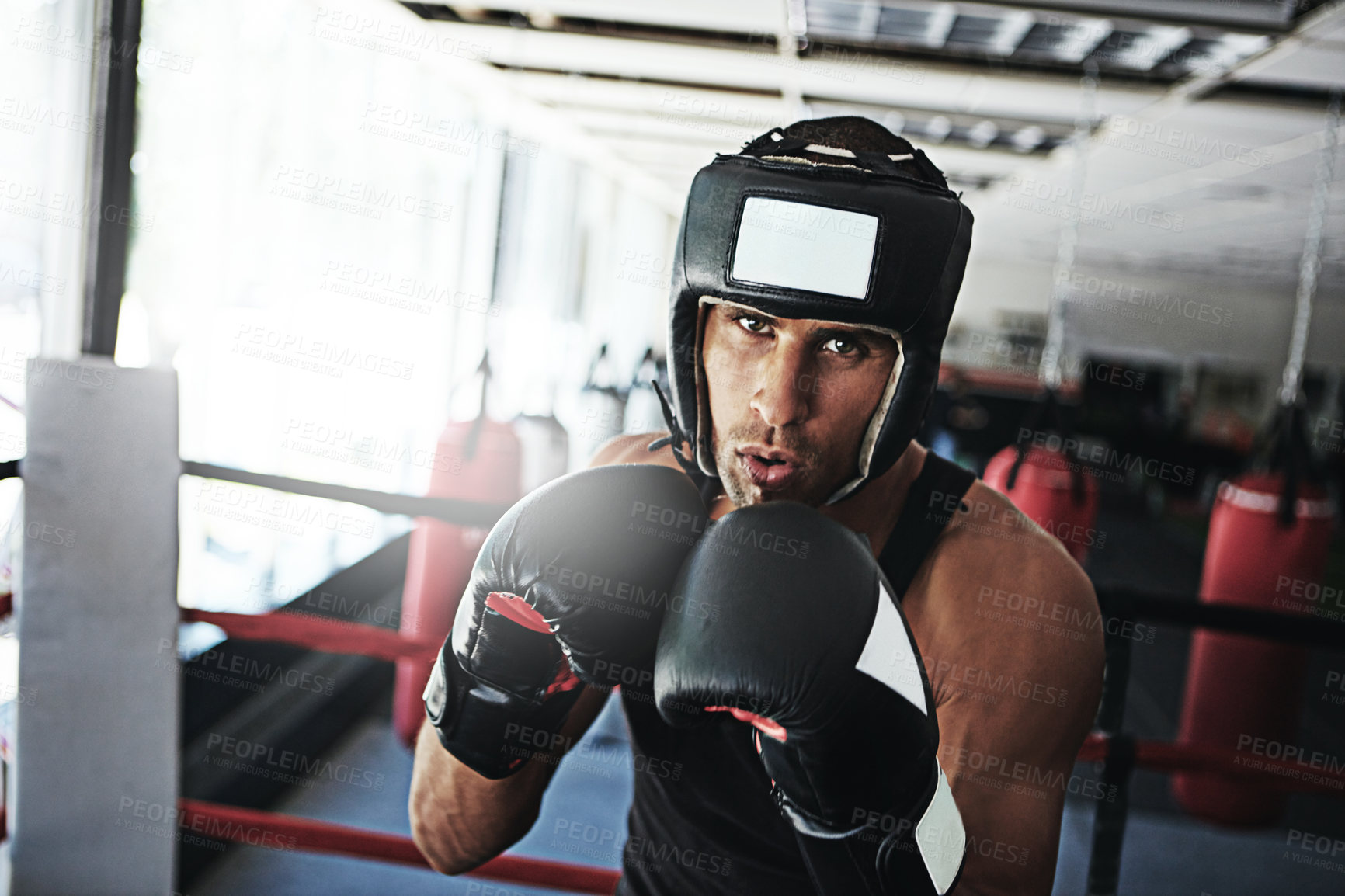 Buy stock photo Portrait of a young man training in a boxing ring